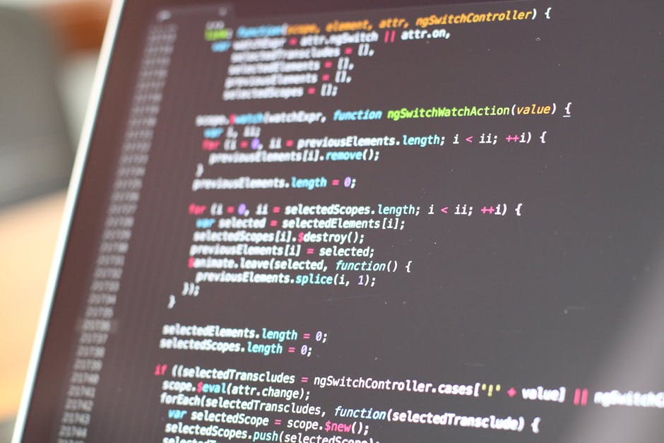 A close-up view of a computer screen displaying colorful HTML code snippets, with tags in shades of blue, green, yellow, and white. The code is related to web development, featuring labels for colors 